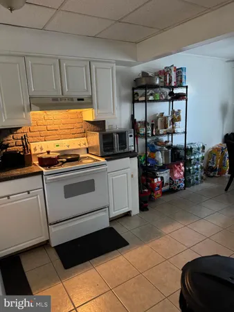 a kitchen with stainless steel appliances a stove a sink and cabinets