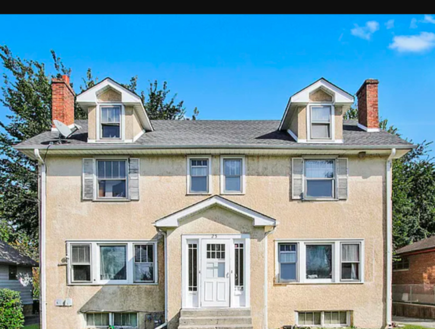 a view of a brick building with large windows