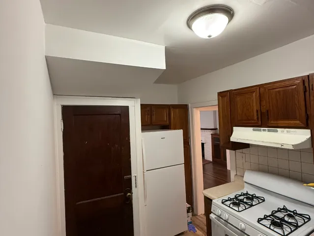 a kitchen with a refrigerator and a stove