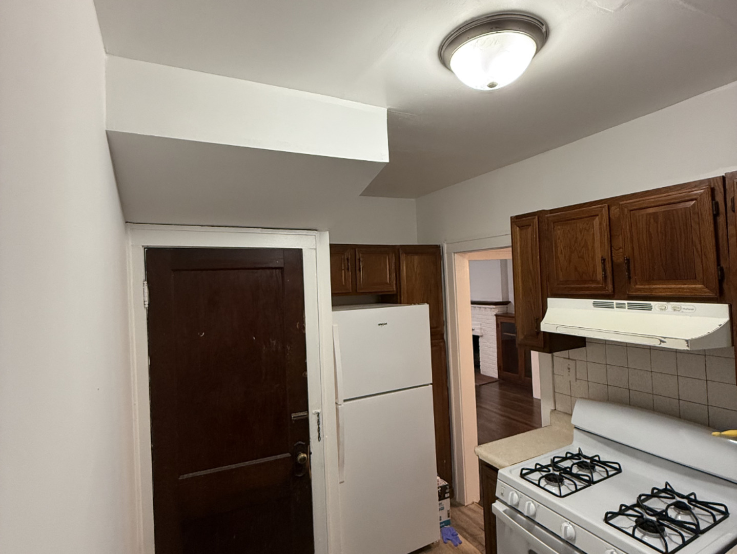 25 Keller Avenue, Unit N Waukegan, IL 60085 - Photo 2 of 6 a kitchen with a refrigerator and a stove