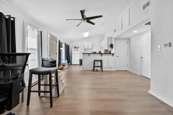 a view of a livingroom with furniture and a ceiling fan