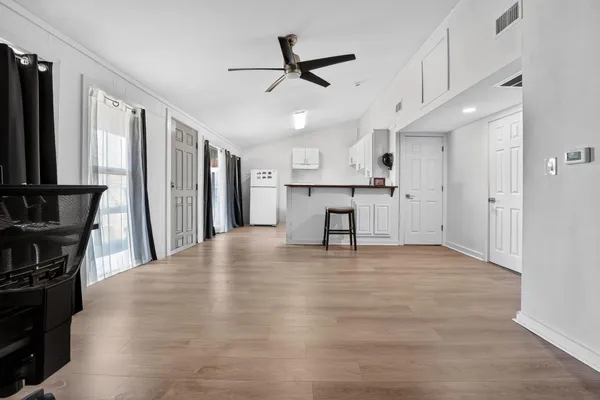 a view of kitchen with furniture and refrigerator