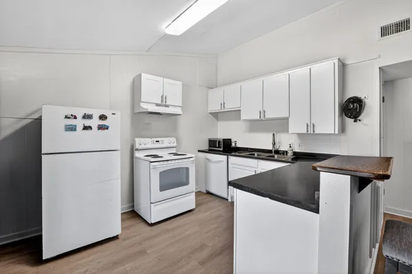 a kitchen with cabinets and stainless steel appliances