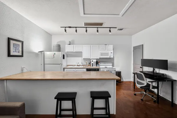 a kitchen with stainless steel appliances a sink and a table