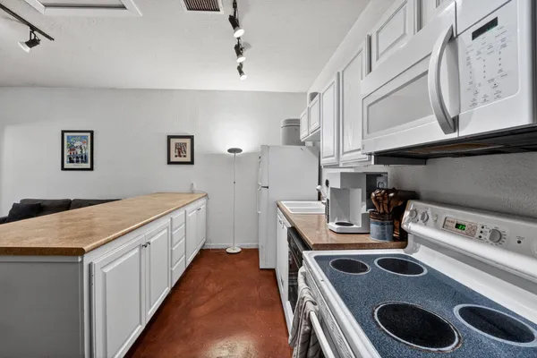 a kitchen with sink stove and cabinets