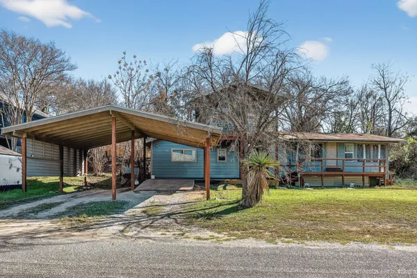 a view of a house with a yard patio and fire pit