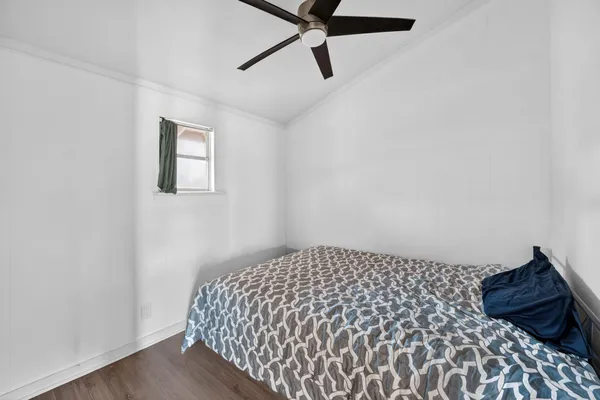 a bedroom with a bed and a painting on the wall