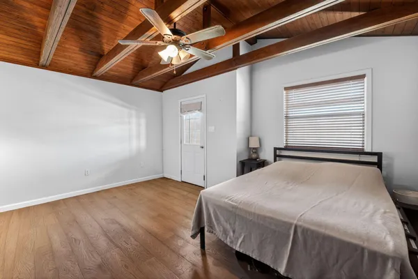 a bedroom with a bed and a ceiling fan