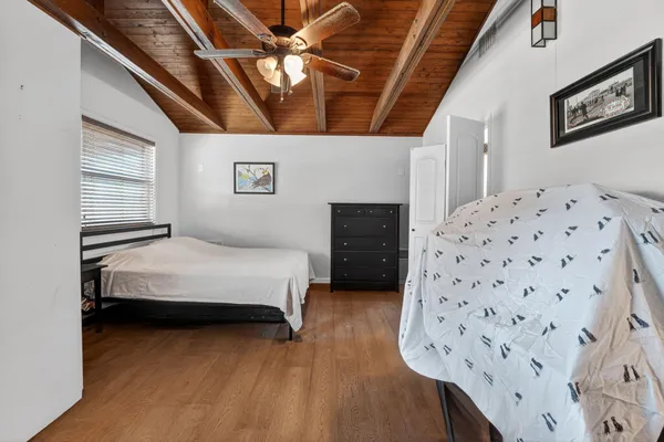 a bedroom with a bed and a dresser