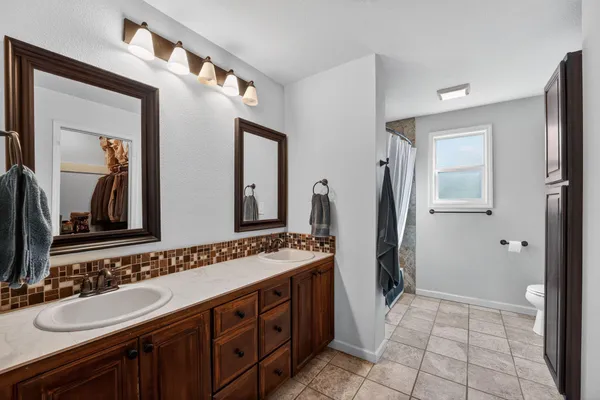 a spacious bathroom with a double vanity sink and a mirror