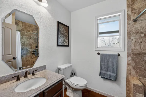 a bathroom with a sink toilet and mirror