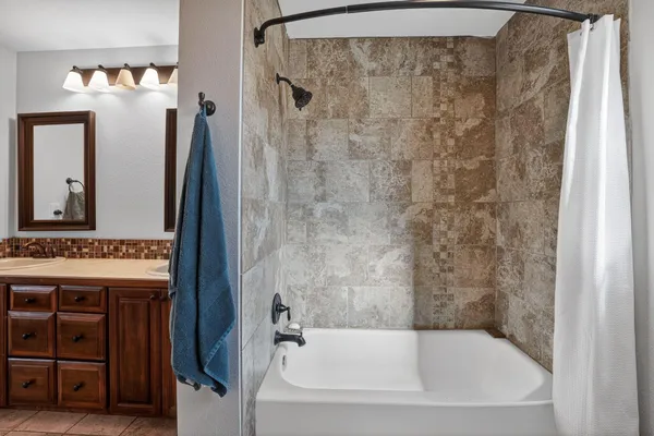 a bathroom with a tub and a sink