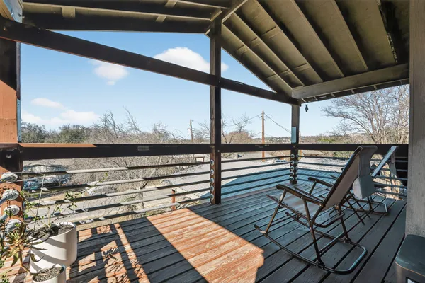 a view of a balcony with wooden floor