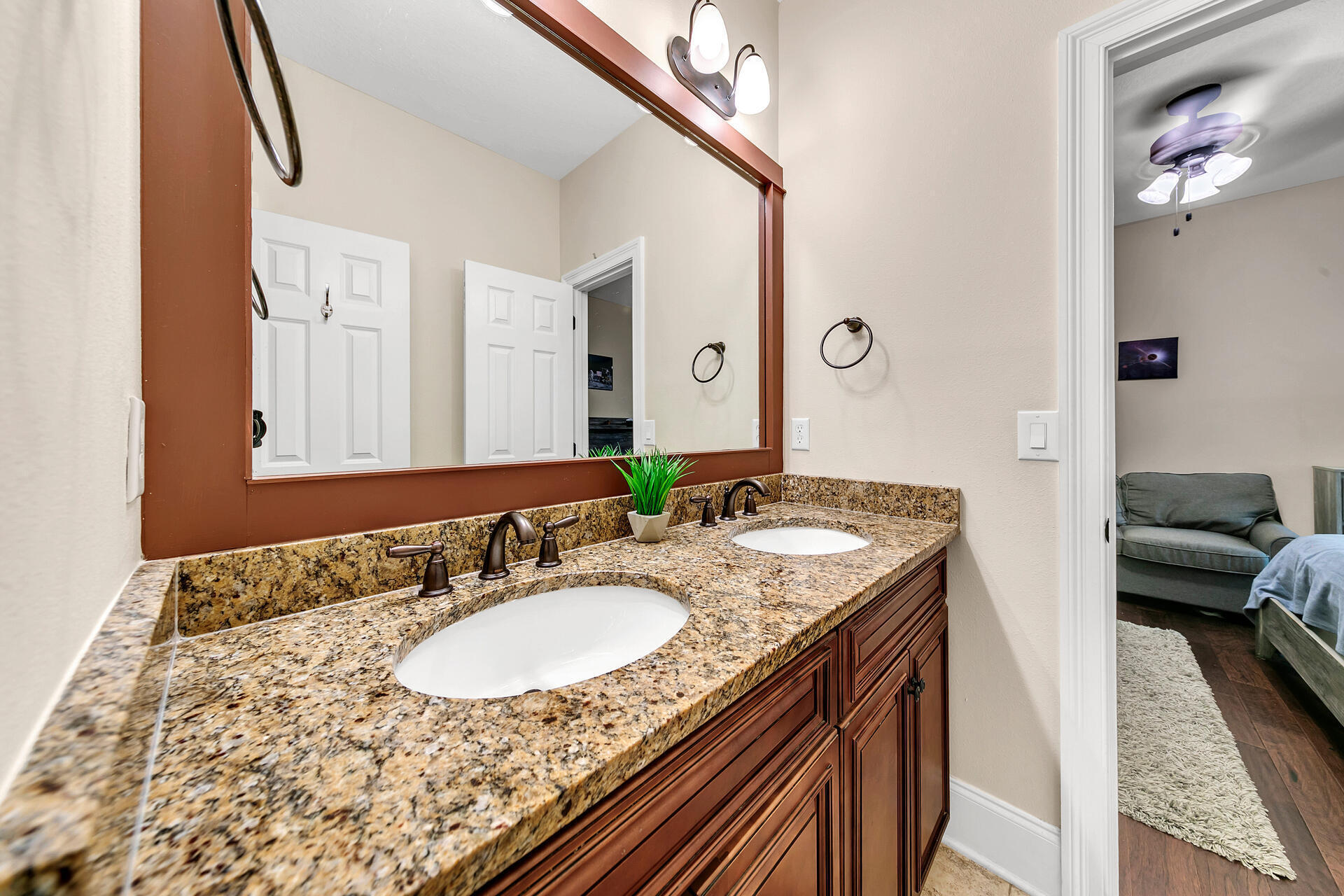 4078 Bond Circle Niceville, FL 32578 - Photo 22 of 37 a en suite bathroom with a granite countertop sink and a mirror
