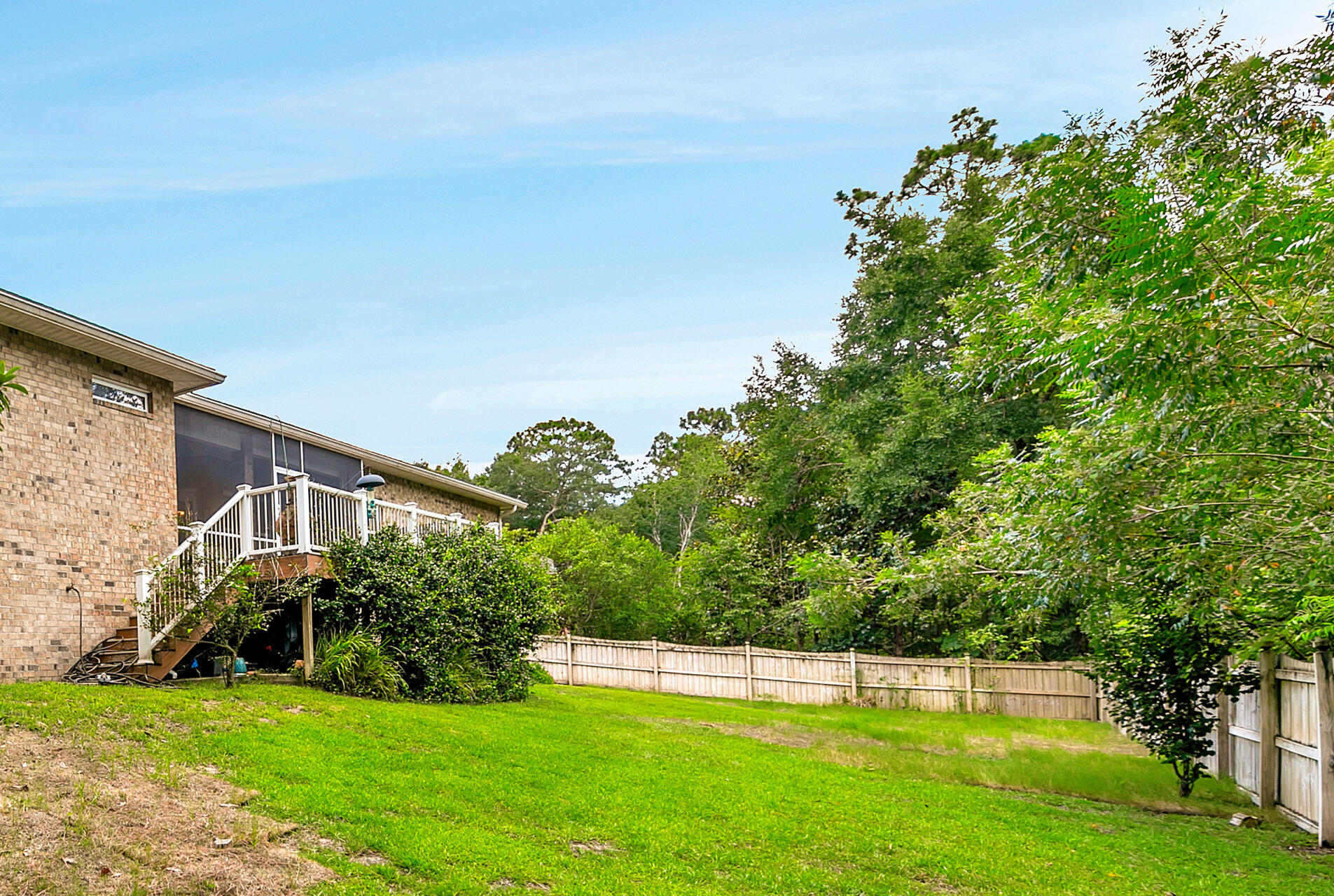 4078 Bond Circle Niceville, FL 32578 - Photo 32 of 37 a view of a house with a big yard potted plants and large tree