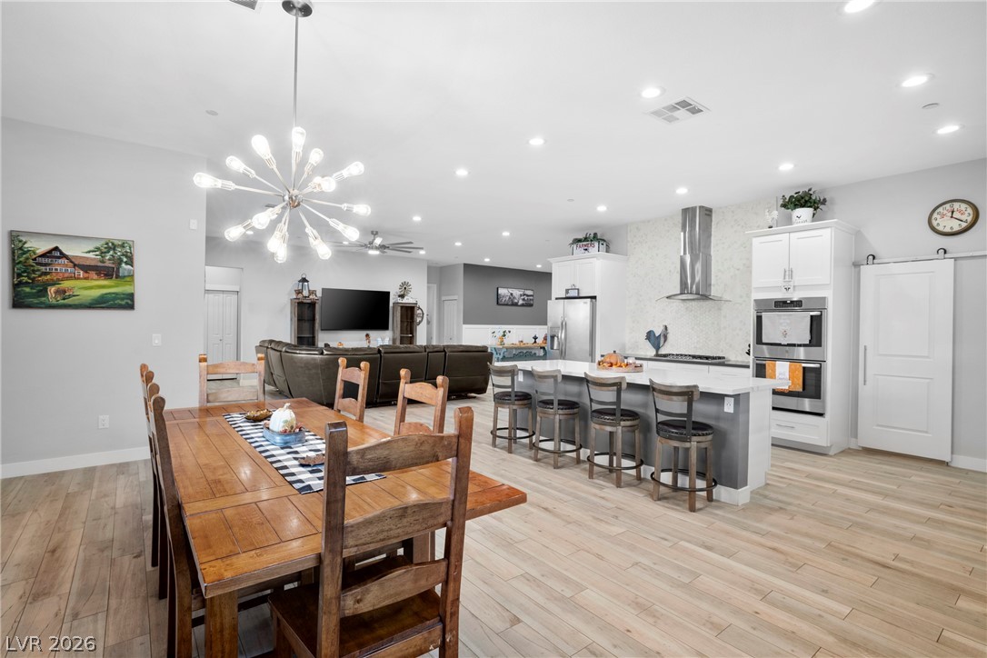 432 North Racetrack Road Henderson, NV 89015 - Photo 28 of 45 Dining space featuring light wood finished floors, hanging lights, and ceiling fan