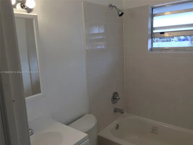 a white bath tub sitting next to a white toilet