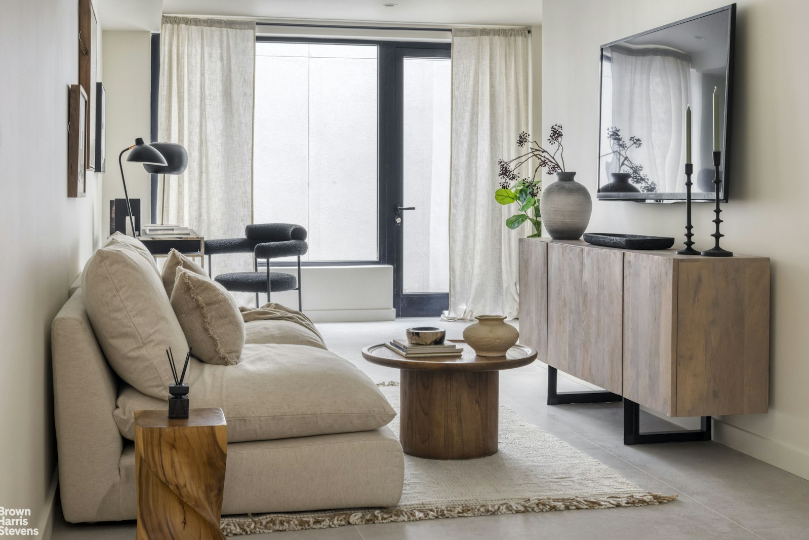 353 20th Street Brooklyn, NY 11215 - Photo 11 of 17 a living room with furniture a large window and potted plants