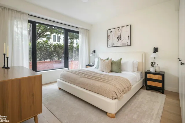 a bedroom with a large bed and a large window