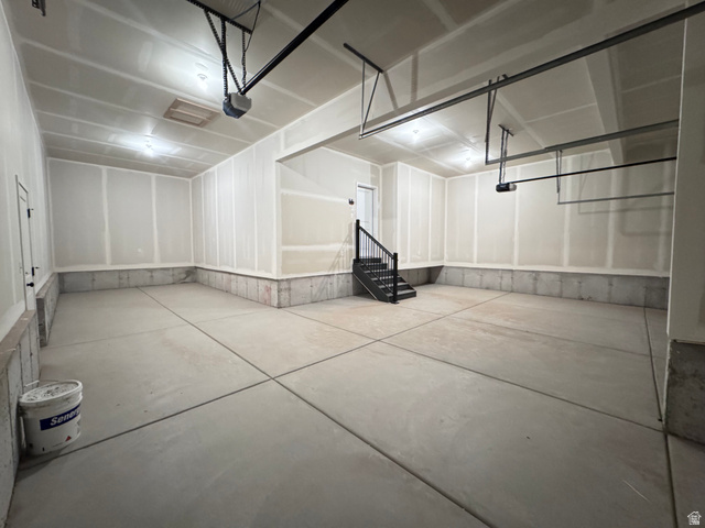2633 Scarlet Road, Unit 259 Eagle Mountain, UT 84005 - Photo 15 of 30 Spacious garage featuring concrete flooring, unpainted drywall walls, and a finished ceiling with recessed lighting