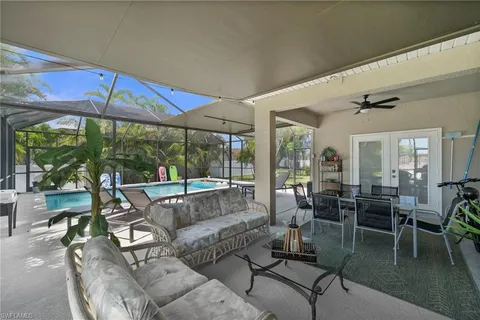 a view of a patio with a table chairs and a backyard