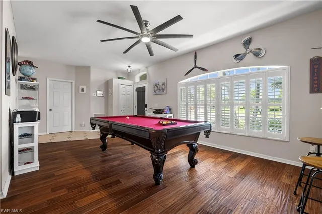 a room with furniture pool table and wooden floor
