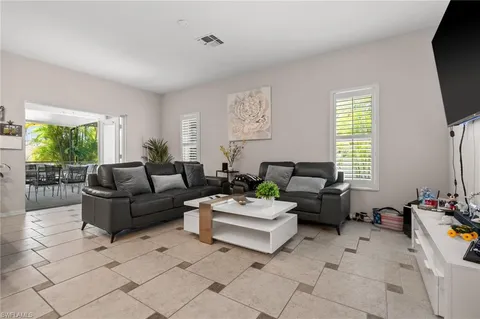 a dining room with furniture and chandelier