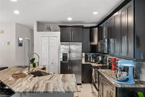 a kitchen with refrigerator and cabinets