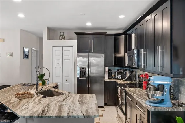 a kitchen with refrigerator and cabinets