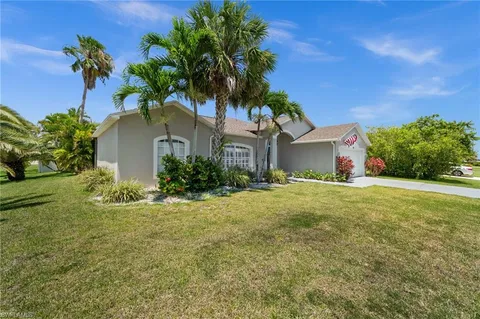a front view of house with yard and trees