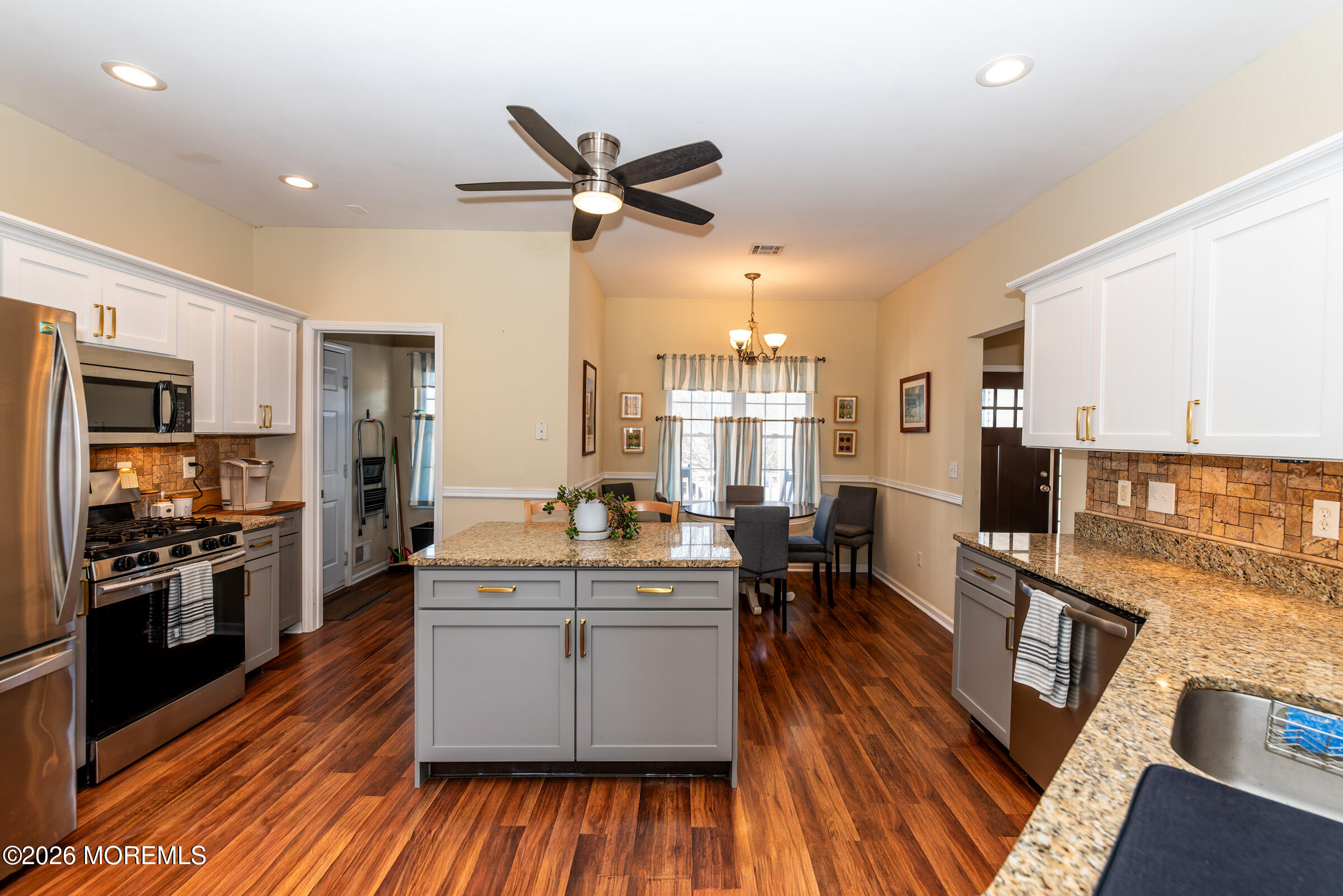 1609 Tamiami Road Forked River, NJ 08731 - Photo 17 of 49 a kitchen with stainless steel appliances kitchen island granite countertop a stove refrigerator and cabinets
