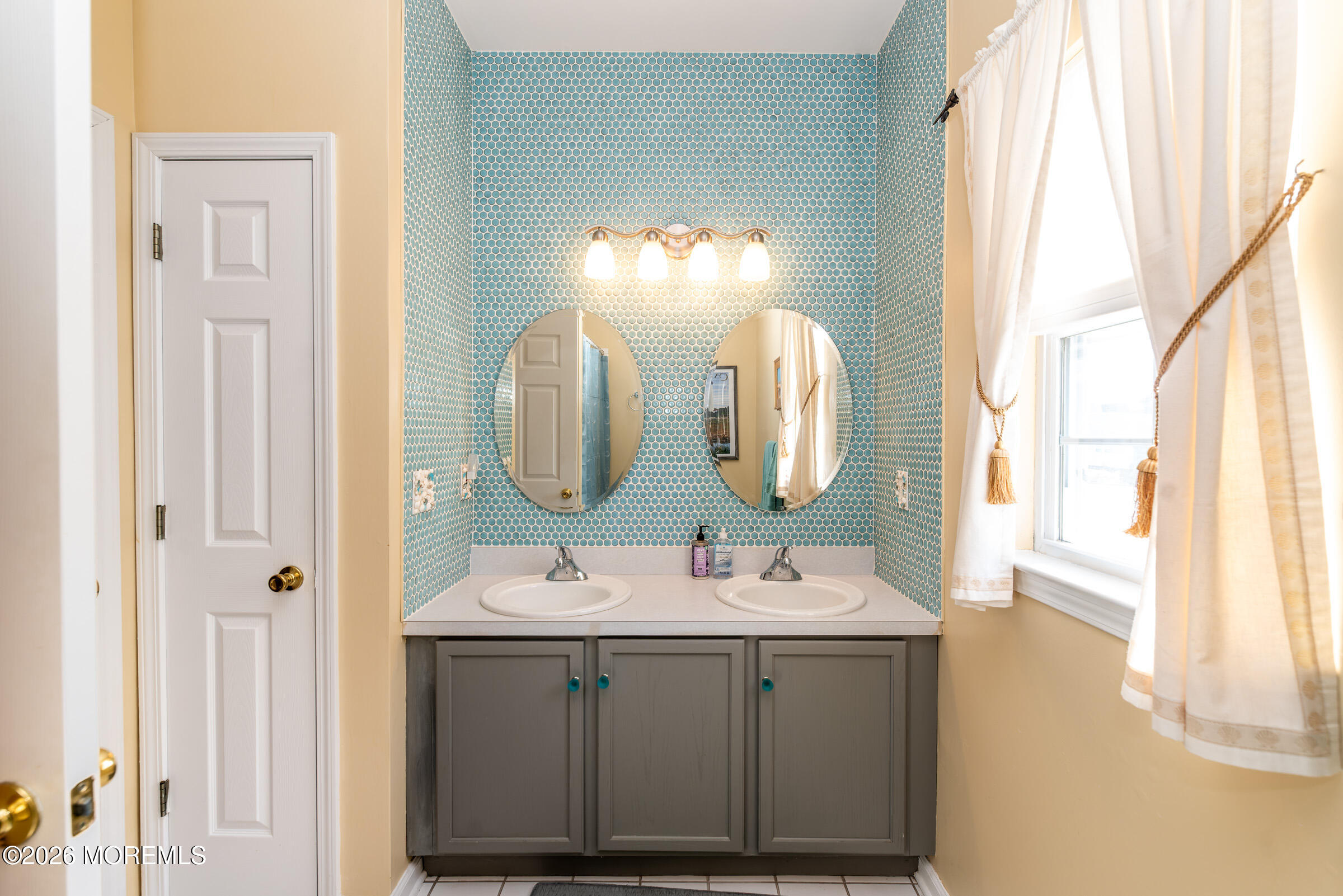 1609 Tamiami Road Forked River, NJ 08731 - Photo 32 of 49 a bathroom with a double vanity sink and a mirror