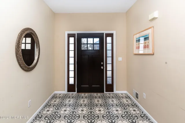 a living room with furniture and a lamp