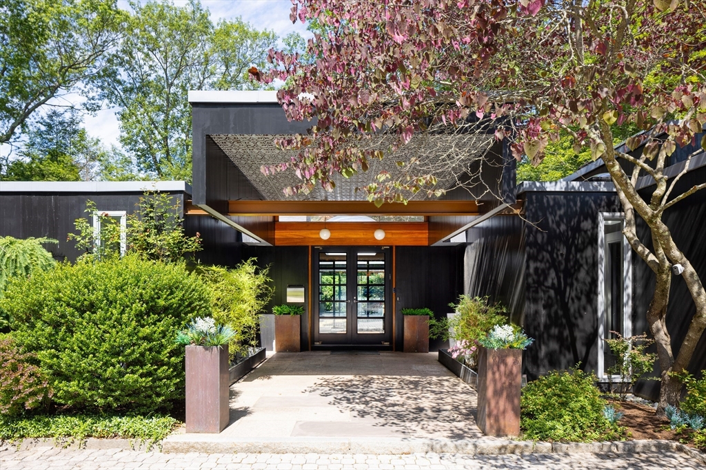 a front view of a house with a garden