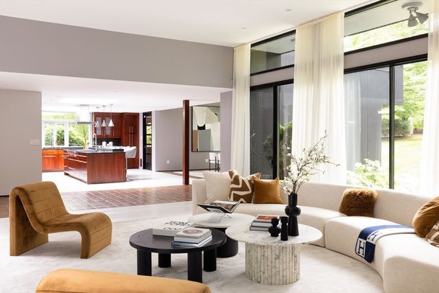 a living room with furniture and large windows