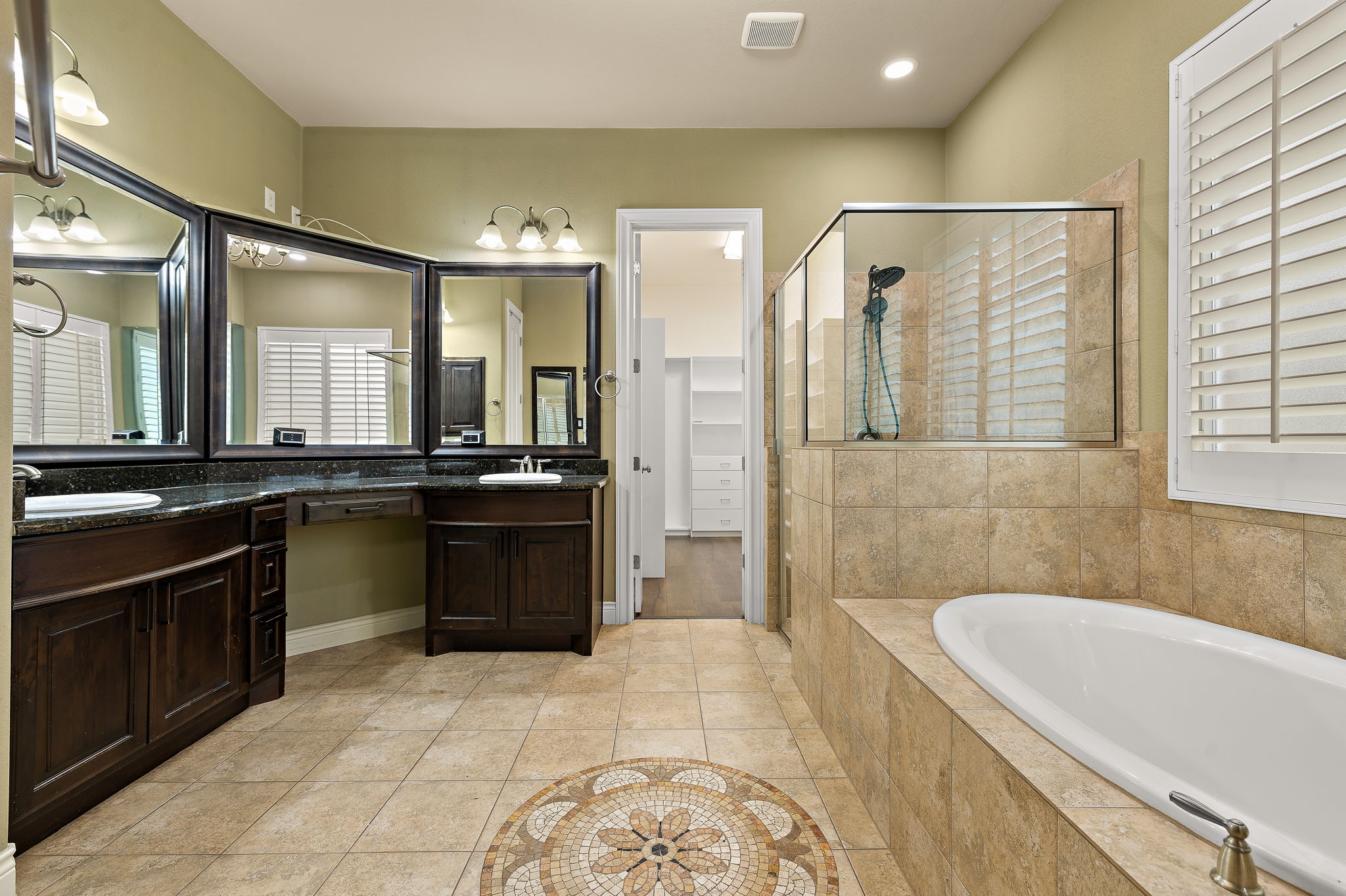 174 Estrella Crossing Georgetown, TX 78628 - Photo 16 of 38 Full bath with a garden tub, double vanity, light tile patterned floors, a stall shower, and a walk in closet
