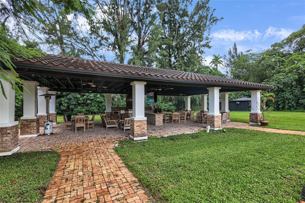 14701 Southwest 63rd Street Southwest Ranches, FL 33330 - Photo 41 of 64 a view of a house with a backyard patio and chairs