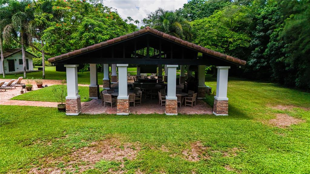 14701 Southwest 63rd Street Southwest Ranches, FL 33330 - Photo 62 of 64 a view of a house with a yard porch and sitting area