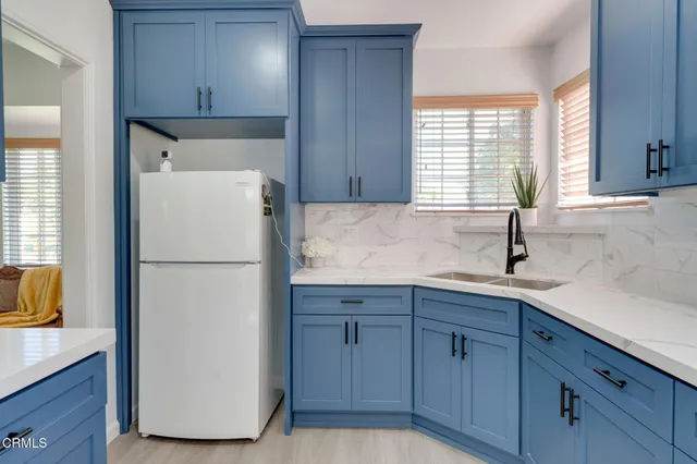 a white refrigerator freezer sitting in a kitchen