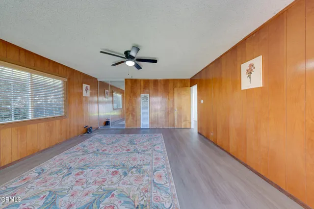a view of a livingroom with a ceiling fan and window