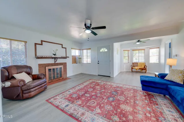 a living room with furniture fireplace and window