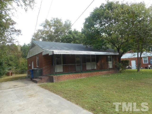 907 Newcombe Road Raleigh, NC 27610 - Photo 2 of 9 a front view of a house with a garden and trees