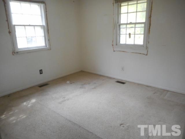 907 Newcombe Road Raleigh, NC 27610 - Photo 6 of 9 an empty room with a window