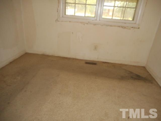 907 Newcombe Road Raleigh, NC 27610 - Photo 7 of 9 an empty room with a window