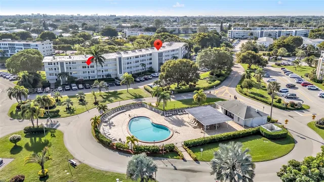 an aerial view of a house with swimming pool and ocean view