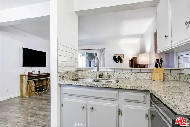 a view of living room with flat screen tv and cabinet