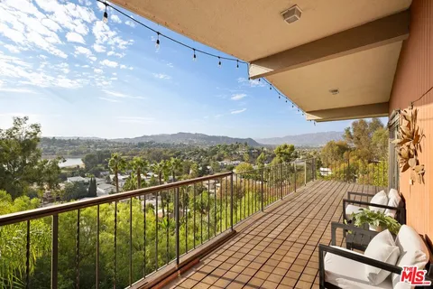 a view of a balcony with wooden floor