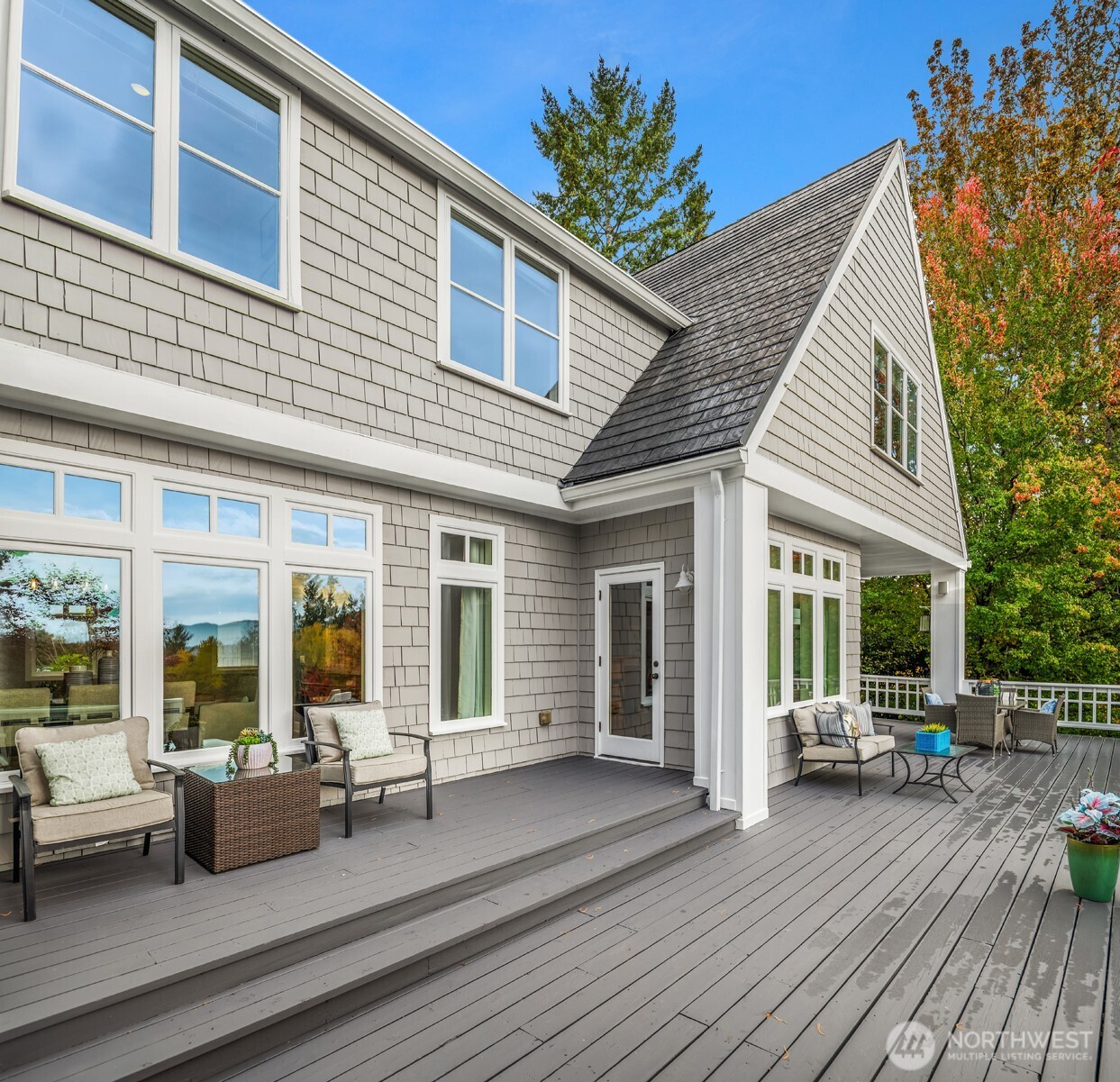 26133 Northeast 34th Street Redmond, WA 98053 - Photo 13 of 40 a patio with couches and table and chairs with wooden floor and fence