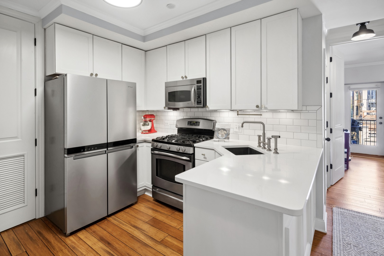 1254 West Eddy Street, Unit 2 Chicago, IL 60657 - Photo 11 of 14 a kitchen with stainless steel appliances a refrigerator a stove a sink cabinets and wooden floor