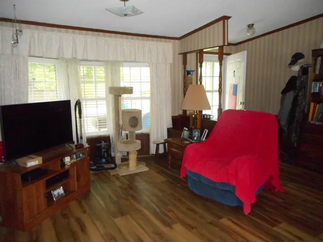 a living room with furniture and a flat screen tv